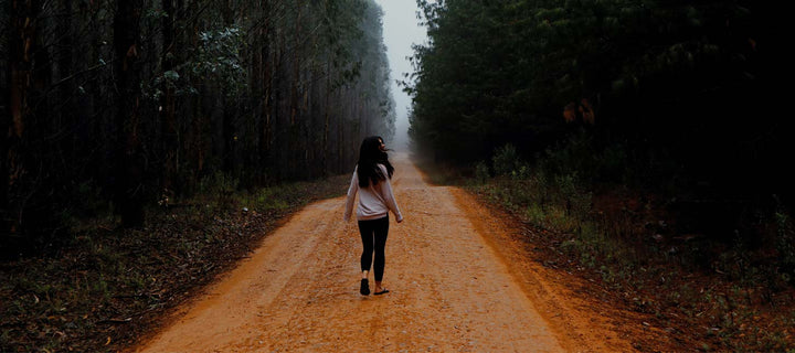 woman walking down long winding road